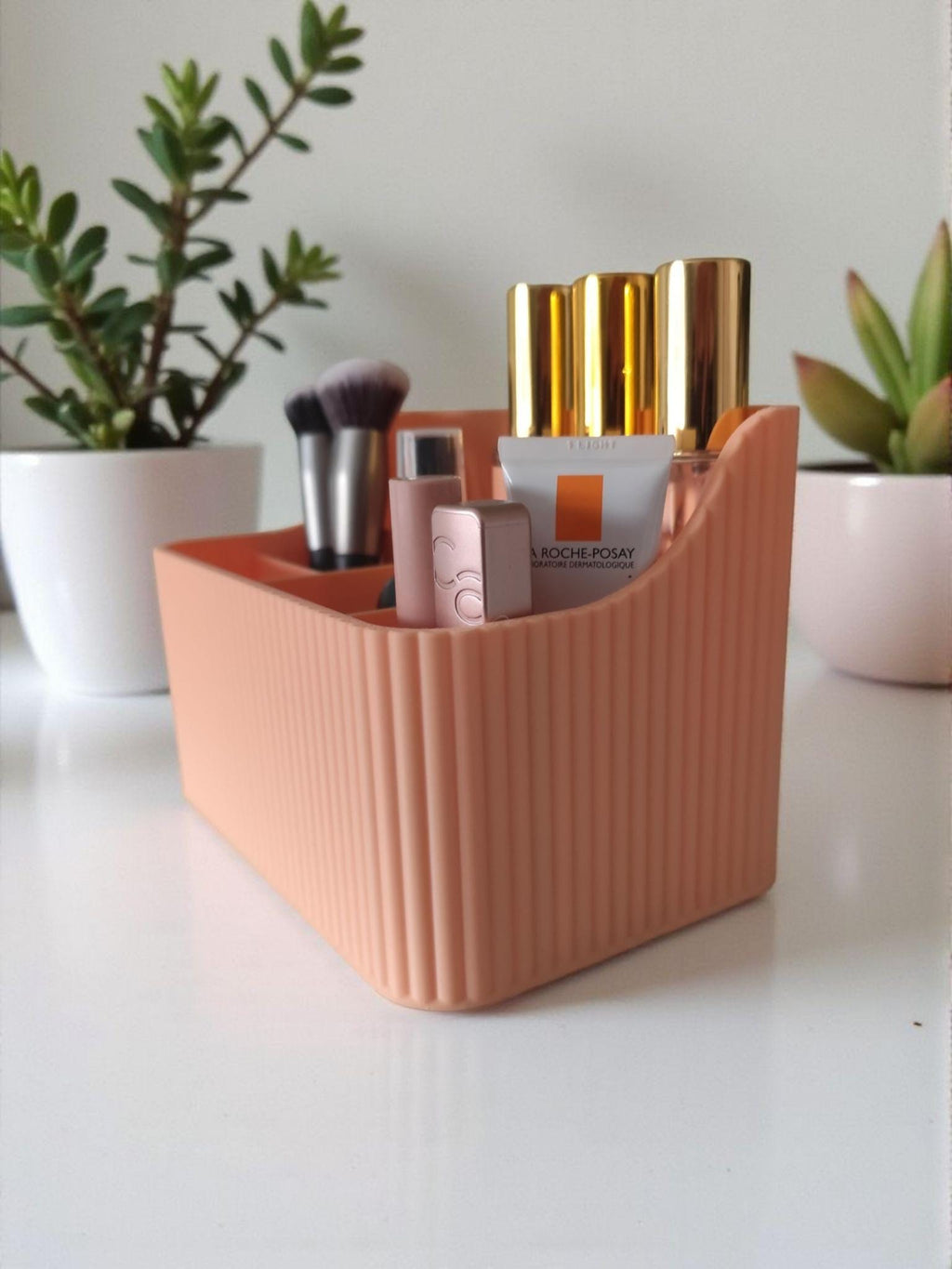 Ribbed six-compartment 3D-printed makeup organiser in peach pink on a vanity, HappyLayerMint Malta